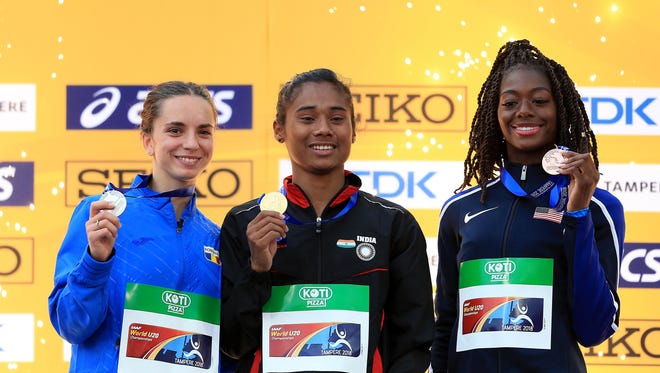 Left to right: Andrea Miklos of Romania, Hima Das of India and Taylor Manson of the USA celebrate with their medals during the medal ceremony for the women's 400-meter run on day three of The IAAF World U20 Championships on July 12, 2018 in Tampere, Finland.