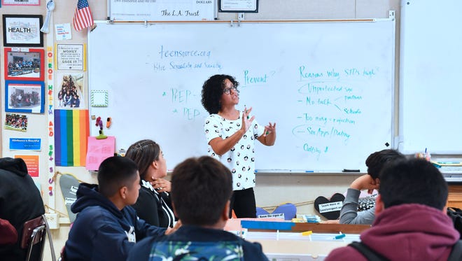 A high school class learns about teen sexual health.