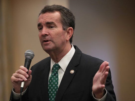 Ralph Northam speaks to residents during a visit to