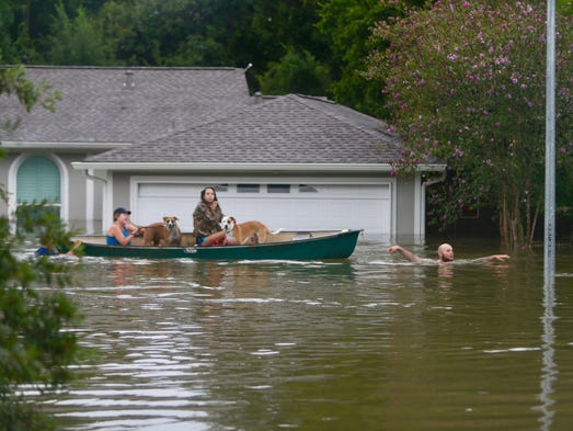 A family evacuates their home in Houston on Aug. 27,