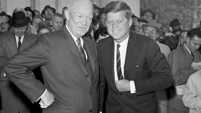 FILE - In this Dec. 6, 1960, file photo, President Dwight Eisenhower poses with President-elect John F. Kennedy at the White House in Washington, before a private conference. Researchers at the John F. Kennedy Presidential Library and Museum in 2020 have found a cache of letters from Americans objecting to JFK's embrace of cocktails at White House events. The letters shed new insight into Eisenhower's handoff to Kennedy early in 1961, and the strikingly different attitudes that people held about alcohol at official functions.