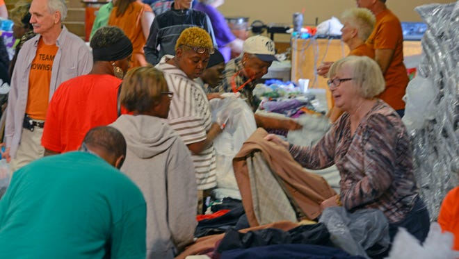 Volunteers hand out free clothes Saturday during the Keep Brownsville Warm event at Brownsville Assembly of God. Volunteers handed out free blankets, jackets, clothes and free soup along with haircuts.