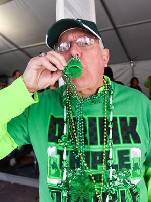 Ralph Fogue of Des Moines has fun drinking beer from