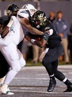 Western Michigan's Jarvion Franklin, right, is tackled by Eastern Michigan's Luke Maclean during the first half of an NCAA football game Thursday, Oct. 29, 2015, in Ypsilanti, Mich.