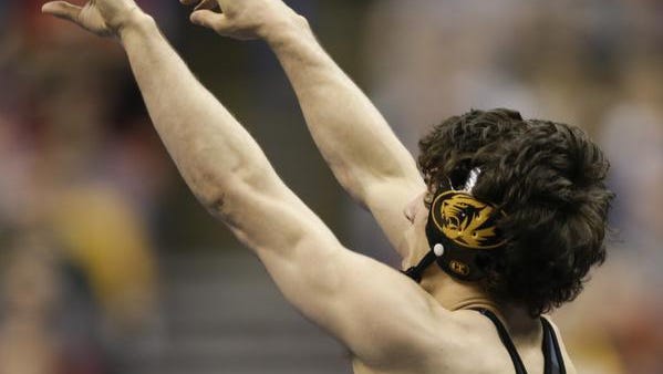 Missouri's Joey Lavallee points to the crowd as he celebrates a victory over Virginia Tech's Sal Mastriani in a 157-pound match in the second round of the NCAA Division I wresting championships last spring.