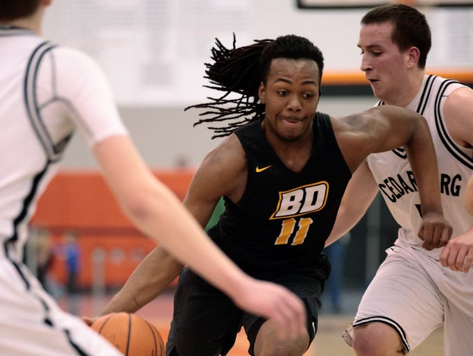 Brown Deer's Jay Gentry (middle) drives from the top