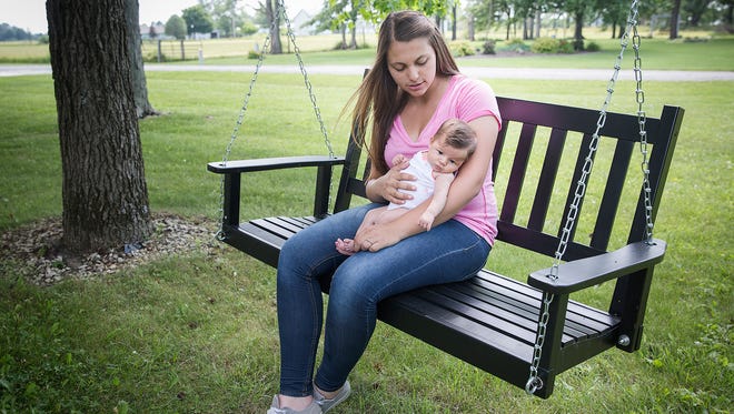 Gabby Fluhler with her baby at their Muncie home Thursday afternoon. 