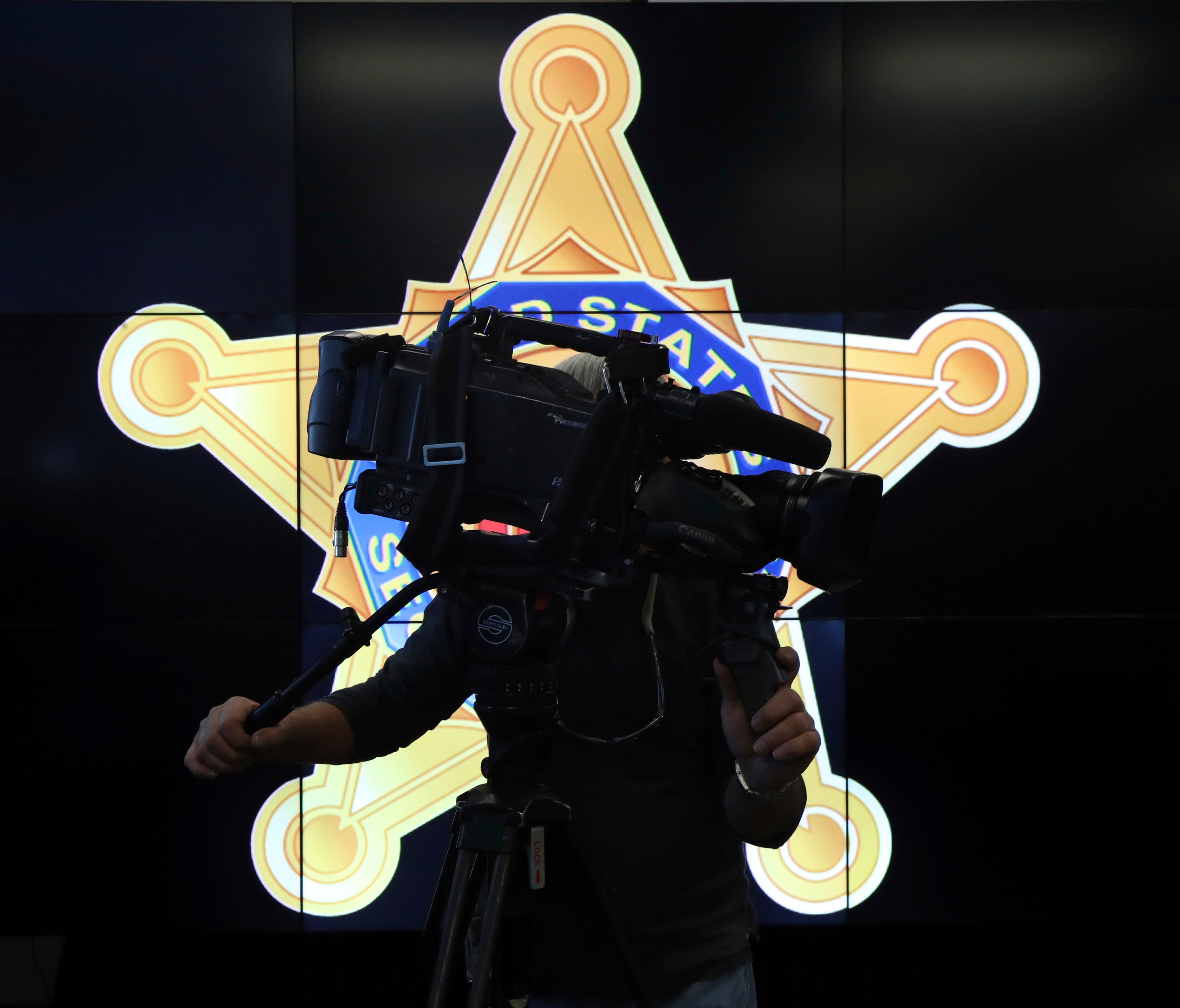 A television cameraman records a news conference in front of the U.S. Secret Service logo, attended by Homeland Security Secretary Jeh Johnson, about the security for the presidential inauguration and activities related to it, Friday, Jan. 13, 2017 a