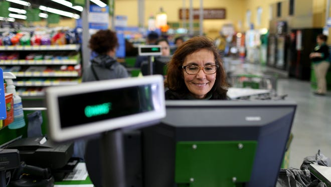 Walmart employee Blanca Mojita rings up customers.