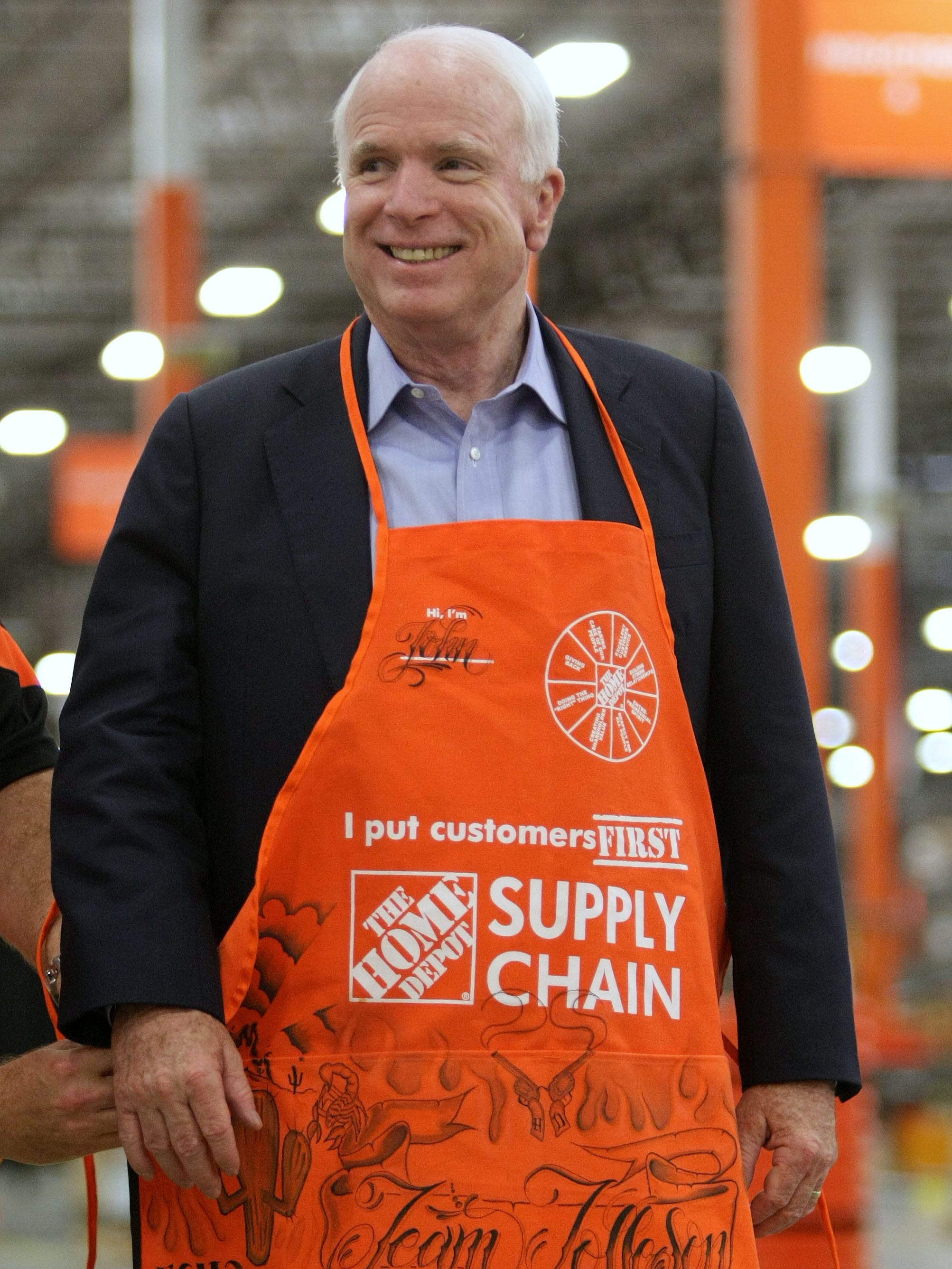 Sen. John McCain gets his own apron after talking to