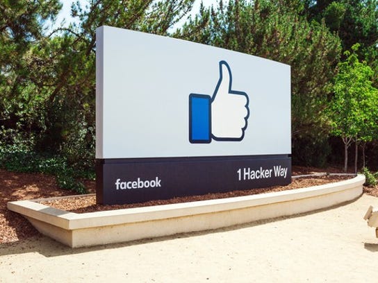 The Facebook thumbs up symbol is shown on a sign at its headquarters