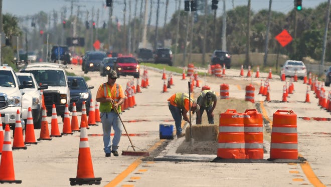 Heat waves shimmering off of Highway A1A on Tuesday afternoon, as workers from a State road crew brave the broiling heat  in Satellite Beach.