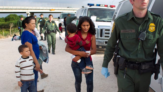 Some of a dozen women and children from Honduras are apprehended by Border Patrol near the Anzalduas International Bridge not far from the border with Mexico at the Rio Grande river in Mission, Tex., on June 21, 2014.