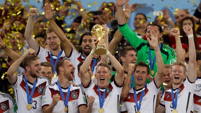 In this July 13, 2014 file photo Germany's Bastian Schweinsteiger holds up the World Cup trophy as the team celebrates their 1-0 victor over Argentina after the World Cup final soccer match between Germany and Argentina at the Maracana Stadium in Rio de Janeiro, Brazil. FIFA is about to make the World Cup a bigger and, it hopes, richer event even at the cost of lower quality soccer. FIFA President Gianni Infantino hopes his ruling Council will agree Tuesday, Jan. 10, 2017 to expand the 2026 World Cup to 48 nations, playing in 16 groups of three teams.