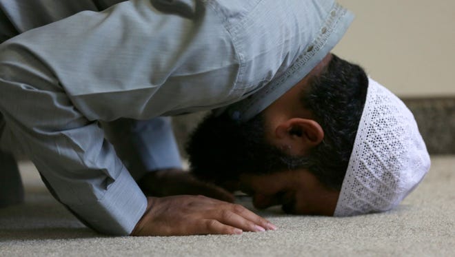 A Muslim man performs sujud during Friday prayers at Masjid Al-Noor, the Marshfield mosque, May 27, 2016.