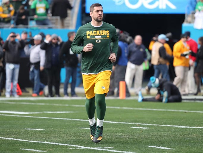Green Bay Packers quarterback Aaron Rodgers runs onto