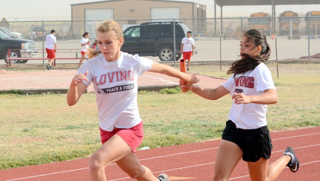 Loving's Bianca Solano hands the baton off to Erica Proudfoot during relay training at Tuesday's practice. The Lady Falcons are off to a strong start again in 2017, already qualifying for state in three relay events.