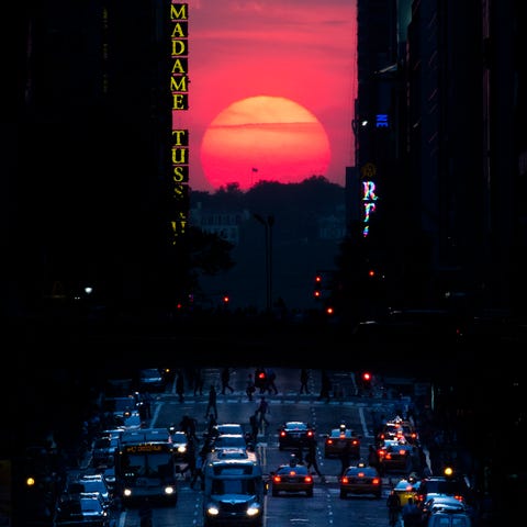 The sun sets along 42nd Street in Manhattan during