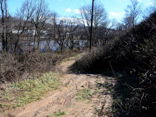 A dirt path marks what is planned to be a greenway