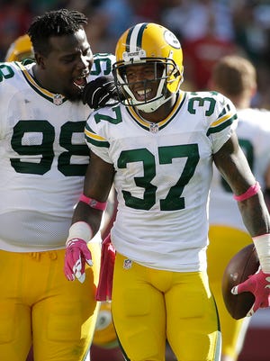 Packers nose tackle Letroy Guion (98) celebrates with cornerback Sam Shields (37) after Shields intercepted a pass from 49ers quarterback Colin Kaepernick during the second half.