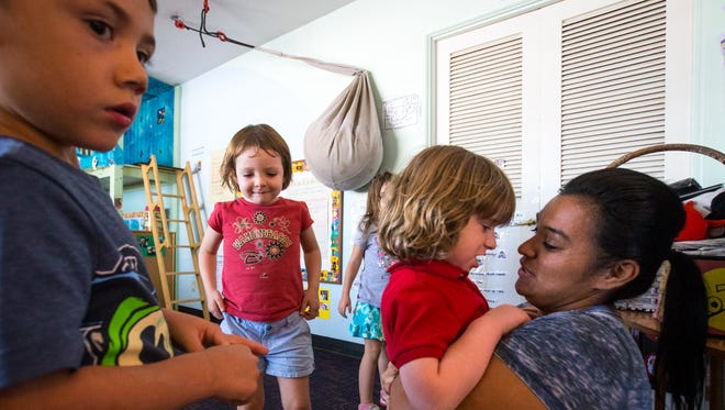(from left) Xavier Jackson and Pearl Swenke play while Brais Macknik-Conde and teacher Anna Hernandez chat Monday at the Family School, a preschool in Phoenix.