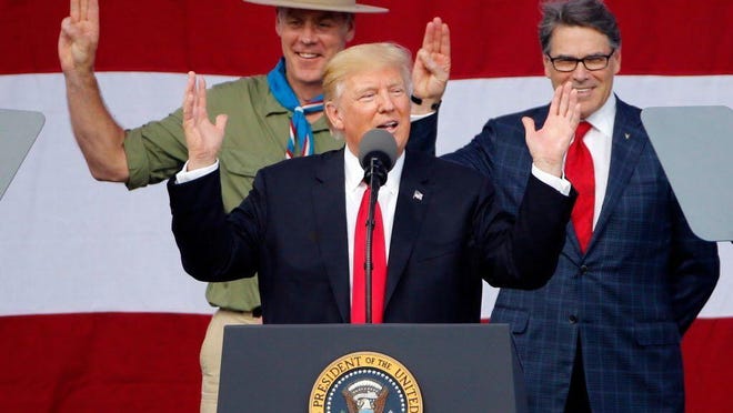 President Trump, front left, gestures as former Boy Scouts Interior Secretary Ryan Zinke, left, and Energy Secretary Rick Perry watch at the 2017 National Boy Scout Jamboree at the Summit in Glen Jean, W.Va., July 24, 2017.