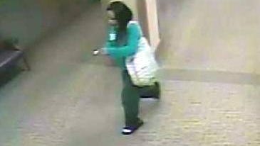 A woman suspected of using a stolen debit card at an ATM inside Ministry Saint Michael’s Hospital is seen on security footage.