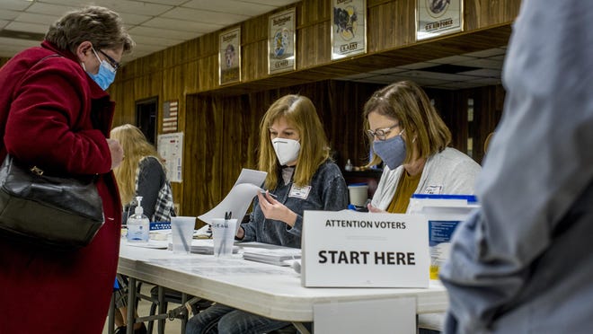 Election judges Trisha Nelms, left, and Toni Evans guide voters through the election process Tuesday at VFW Post 4835 in Creve Coeur.