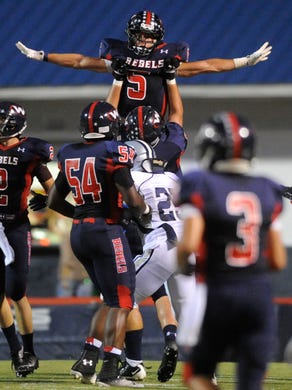 West's Nathan Cottrell (5) is hoisted by teammates after scoring a touchdown, giving West a 6-0 lead over Farragut in the first half of a high school football game at West High School in Knoxville on Friday, Sept. 20, 2013. 