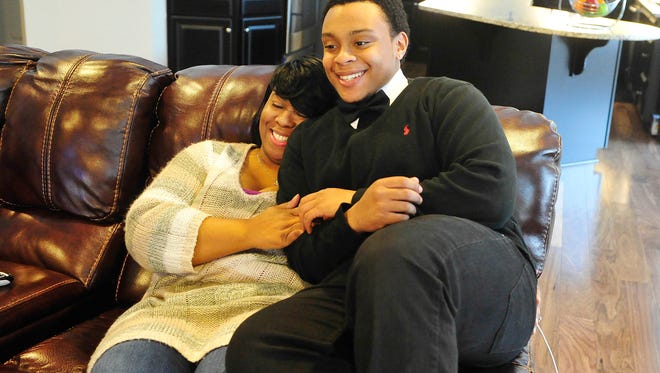 Tahj Turnley, 17, hugs his mother, Tiffani Adams, in their Williamson County home.