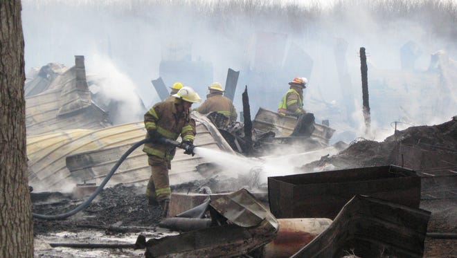 Firefighters from multiple departments battle a fire in the town of Rock Friday afternoon