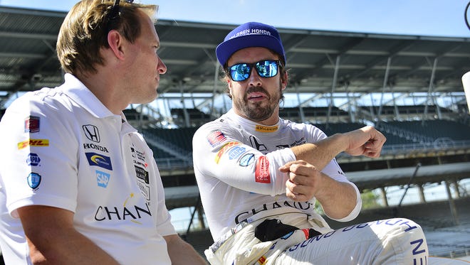 McLaren-Honda-Andretti IndyCar driver Fernando Alonso (29) talks with a crew member during practice for the Indianapolis 500 Tuesday, May 16, 2017, afternoon at the Indianapolis Motor Speedway.