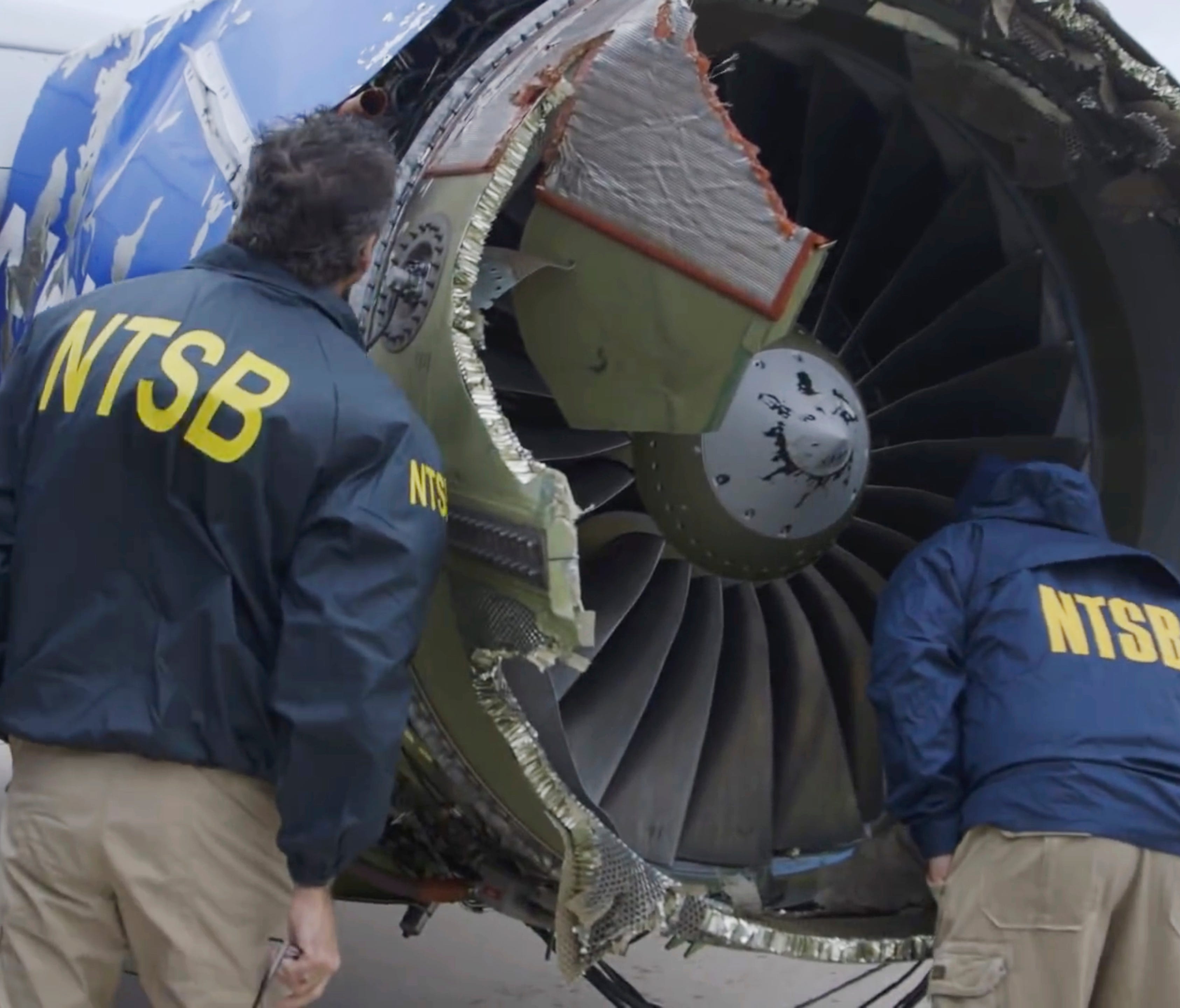 National Transportation Safety Board investigators examine damage to the engine of the Southwest Airlines plane that made an emergency landing at Philadelphia International Airport in Philadelphia on April 17, 2018.