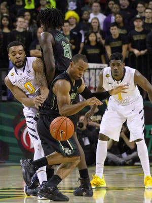 Baylor's Lester Medford (11) looses control of the ball as Taurean Prince (21) sets a screen.