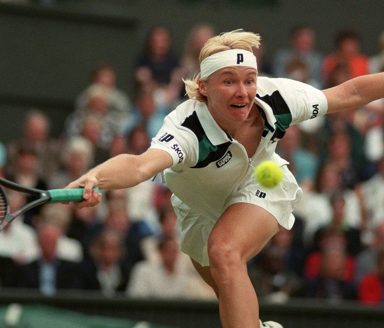 FILE - In this July 4, 1998 file photo, Jana Novotna of the Czech Republic, stretches to make a return to Nathalie Tauziat of France, during the women's singles final match on Wimbledon's Centre Court.  Women's Tennis Association says 1998 Wimbledon 