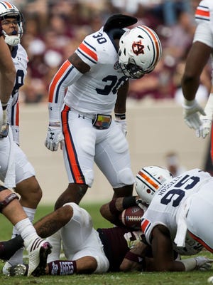 Auburn linebacker Tre' Williams (30) reacts after stopping Texas A&M running back Trayveon Williams (5) on a run during the first half of an NCAA college football game on Saturday, Nov. 4, 2017, in College Station, Texas. (AP Photo/Sam Craft)