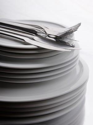 Cutlery on stack of plates