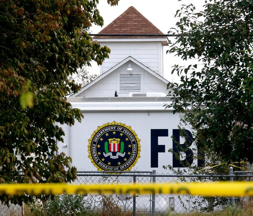 A FBI truck sits in front of the church while investigators worked at the scene of a mass shooting at the First Baptist Church in Sutherland Springs, Tex. The FBI had access to the shooter's cell phone but couldn't access its contents.