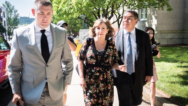 Wanda Greene, former Buncombe County Manager, walks from the federal courthouse with her attorney Thomas Amburgey and Noell Tin, Wednesday, June 13, 2018, after appearing before a U.S magistrate judge where she was indicted on additional charges of using public money to buy life insurance policies for herself and other employees, entering a plea of not guilty. Greene was indicted in April on charges of wire fraud, conspiracy, embezzlement and aiding and abetting.