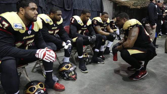 Players with the Iowa Barnstormers huddle together during an Arena Football League game between the Iowa Barnstormers and the LA KISS on Saturday, April 19, 2014, at Wells Fargo Arena in Des Moines, Iowa.