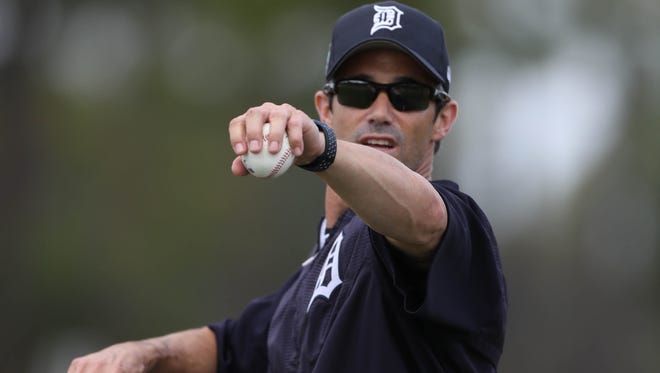 Tigers manager Brad Ausmus pitches batting practice during a workout in spring training on Feb. 19, 2017, in Lakeland, Fla.