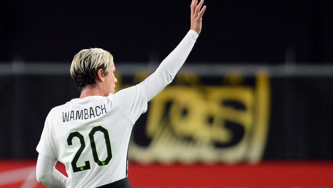Abby Wambach salutes fans during a game against China Dec. 13 at the University of Phoenix Stadium.