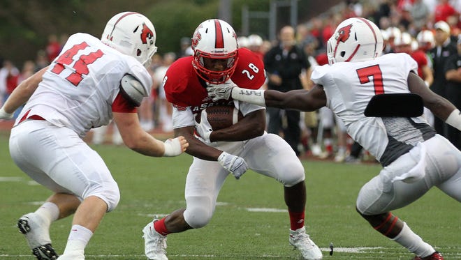 La Salle running back Jeremy Larkin takes on two defenders during a Sept. 11 game win over Colerain.