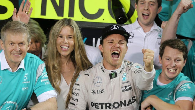 Mercedes driver Nico Rosberg of Germany, center, celebrates with his team in the team garage after the Emirates Formula One Grand Prix at the Yas Marina racetrack in Abu Dhabi, United Arab Emirates, Sunday, Nov. 27, 2016. Rosberg placed second in the race as well as becoming the 2016 world champion. (AP Photo/Kamran Jebreili)