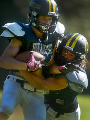 Eric Weckbacher is tackled by teammate Cody Timm during Hillcrest Christian’s practice on Wednesday in Thousand Oaks. The eight-man program opened its season with a 72-0 win last Friday.