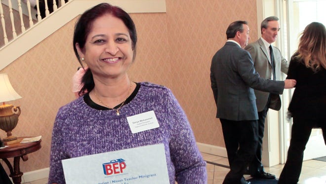 Oakland Middle School teacher Sariya Mohammed smiles with a certificate honoring her BEP mini-grant in hand. Mohammed was chosen for her "Marching Towards Mechatronics" program.