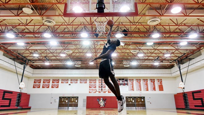 Jarace Walker demonstrates a one-handed dunk last month at Susquehannock High School. The 6-foot-2 seventh-grade student at Southern Middle School is a starter for the ninth-grade team. He's also rated as one of the top AAU players in the nation for his age. But will he bolt to play for a private high school and basketball power in Maryland? "I want him to do what's best for him. Of course, we'd love for him to stay in our program," said Susquehannock varsity coach John Zerfing. The coach pointed out this comparison: Spring Grove's Eli Brooks "has shown you can tour the AAU circuit, get college looks and stay close to home and raise your school and basketball program to levels we haven't seen before."
