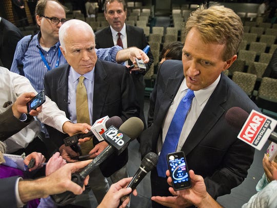 Sens. John McCain (left) and Jeff Flake answer questions