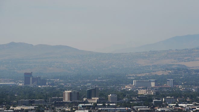 A file photo showing a thick layer of haze covering Truckee Meadows in July 2016. Reno forecasters say a dry, cold front that's moving through the region is bringing gusty winds, covering the area in dust.