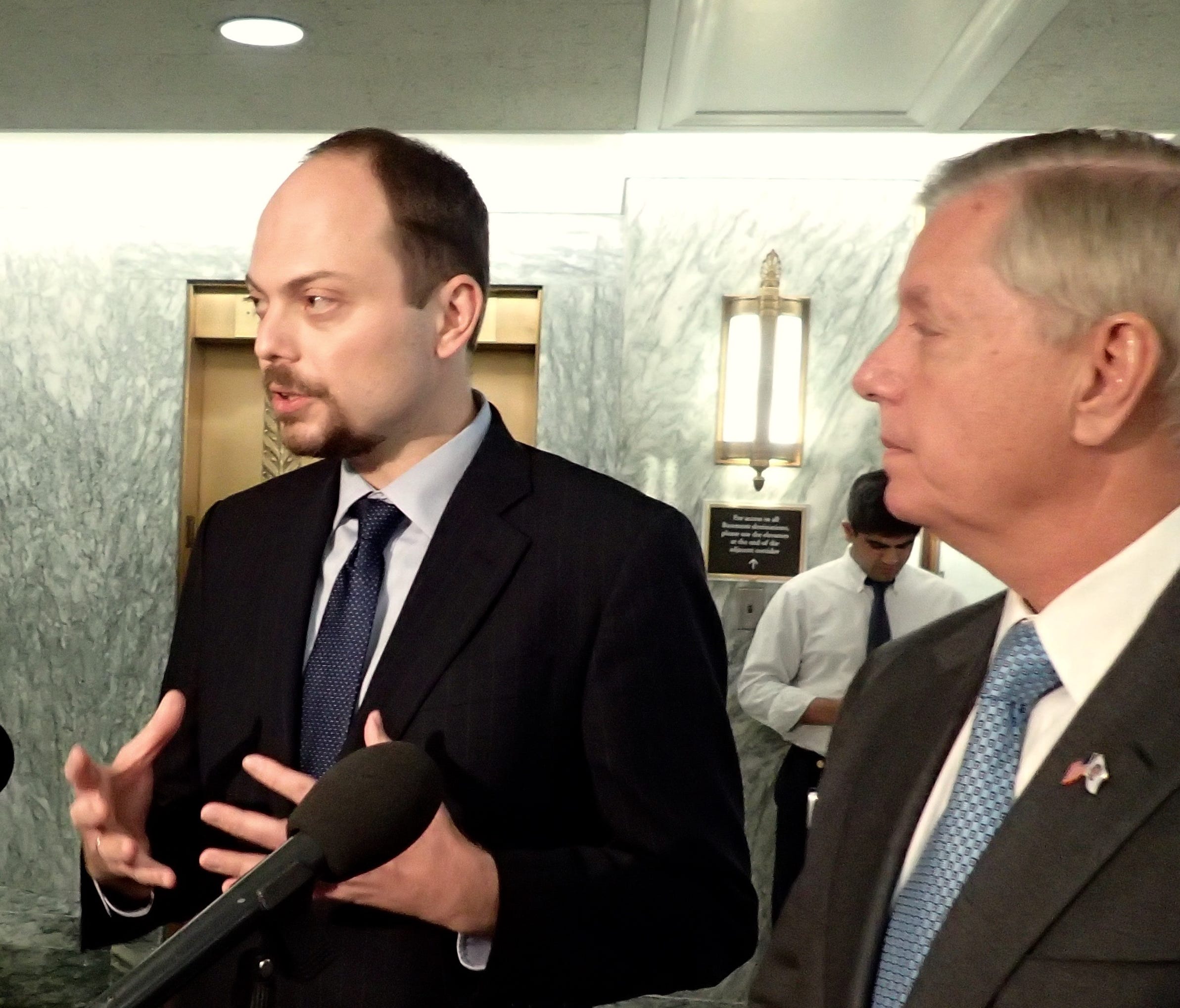 Russian activist Vladimir Kara-Murza talks to reporter on Capitol Hill with Sen. Lindsey Graham, R-S.C., about official corruption and political intimidation in Vladimir Putin's Russia, March 29, 2017.